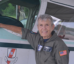 Auxiliary Sector Coordinator, Elsie Metcalf standing next to an Auxiliary airplane